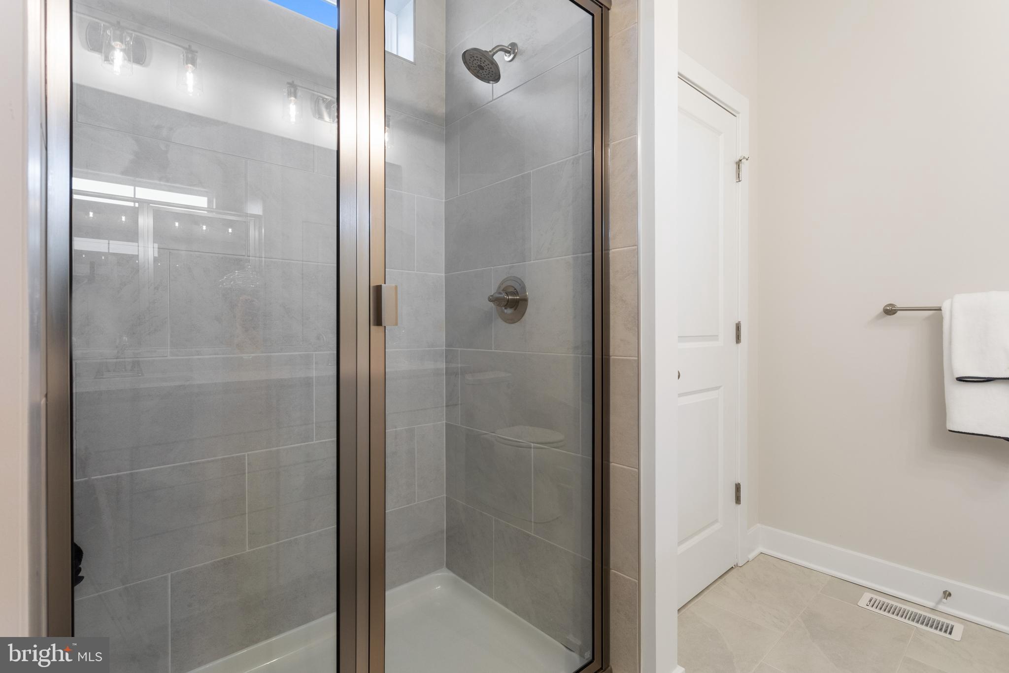 Tbb Wetherby Circle, Unit ALOHA Millsboro, DE 19966 - Photo 9 of 21 a bathroom with a glass shower door