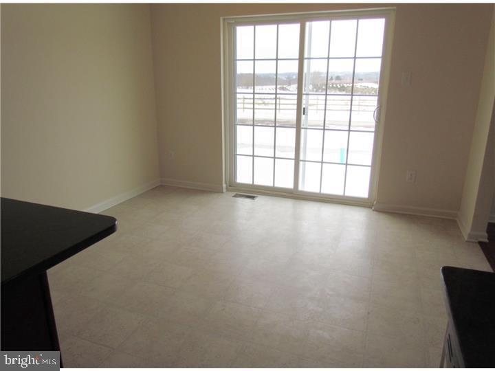 3889 Cephas Child Road, Unit 13 Doylestown, PA 18902 - Photo 14 of 25 an empty room with wooden floor and windows