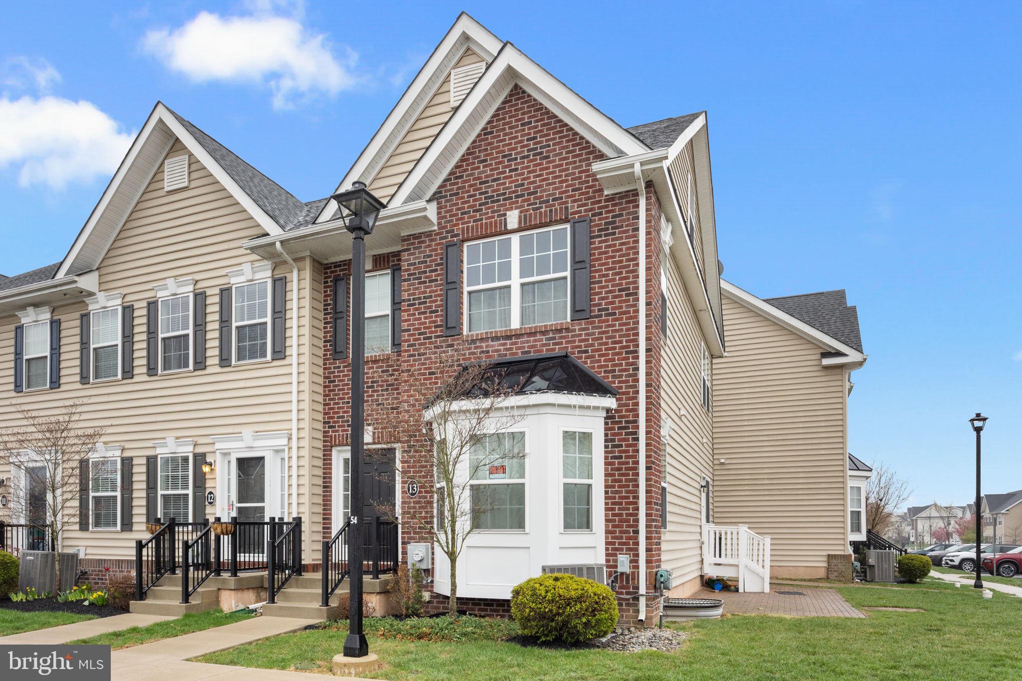 3889 Cephas Child Road, Unit 13 Doylestown, PA 18902 - Photo 2 of 25 a front view of a house with a garden