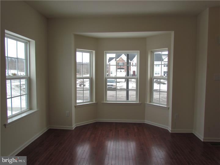3889 Cephas Child Road, Unit 13 Doylestown, PA 18902 - Photo 7 of 25 an empty room with wooden floor and windows