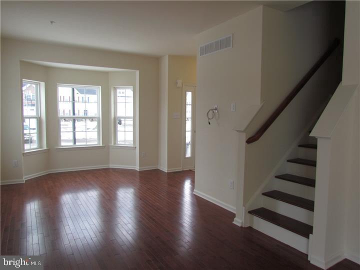 3889 Cephas Child Road, Unit 13 Doylestown, PA 18902 - Photo 8 of 25 wooden floor in an empty room with a window