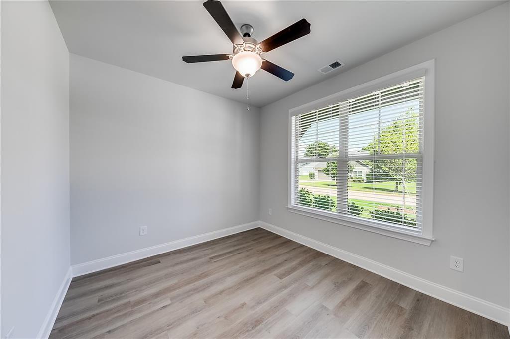 118 Classic Overlook Homer, GA 30547 - Photo 23 of 42 a view of an empty room with wooden floor and a window