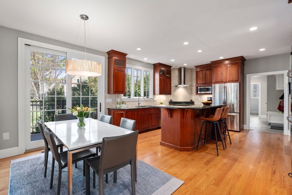 22 Oakencroft Road Wellesley, MA 02482 - Photo 13 of 40 a kitchen with a dining table chairs and refrigerator
