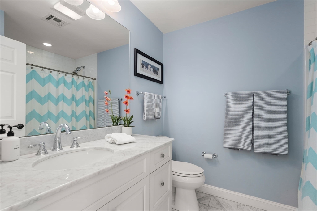 22 Oakencroft Road Wellesley, MA 02482 - Photo 29 of 40 a bathroom with a granite countertop sink mirror vanity and toilet