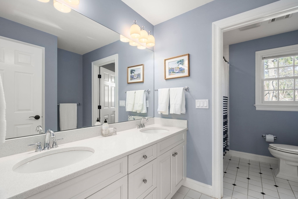22 Oakencroft Road Wellesley, MA 02482 - Photo 31 of 40 a bathroom with double vanity sink a mirror and a toilet