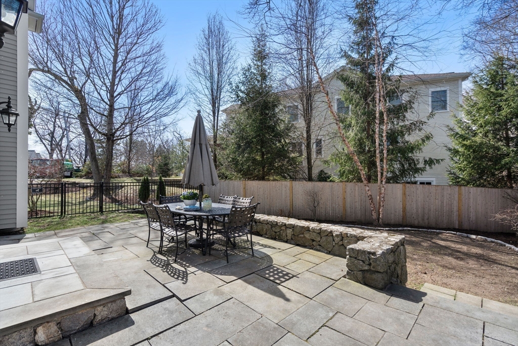 22 Oakencroft Road Wellesley, MA 02482 - Photo 36 of 40 a view of a patio with table and chairs potted plants and large tree