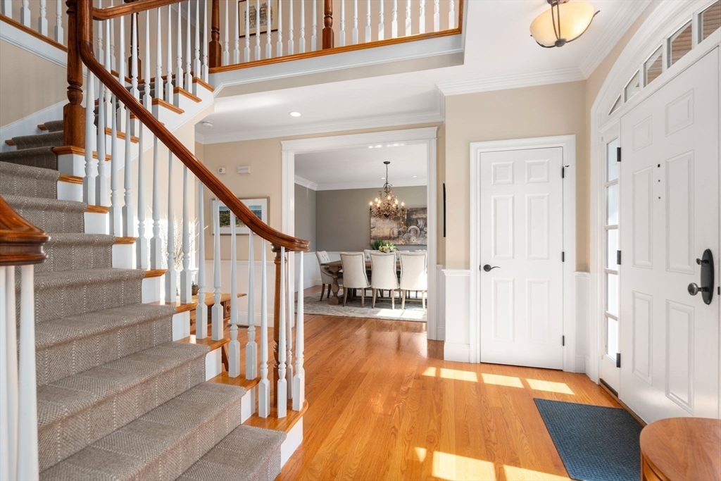 22 Oakencroft Road Wellesley, MA 02482 - Photo 4 of 40 a view of front door with wooden floor and stairs