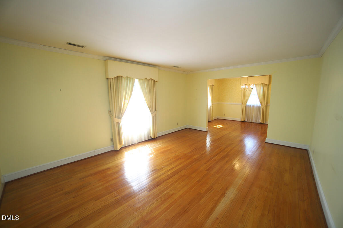 3518 Randolph Road Durham, NC 27705 - Photo 15 of 32 an empty room with wooden floor and windows
