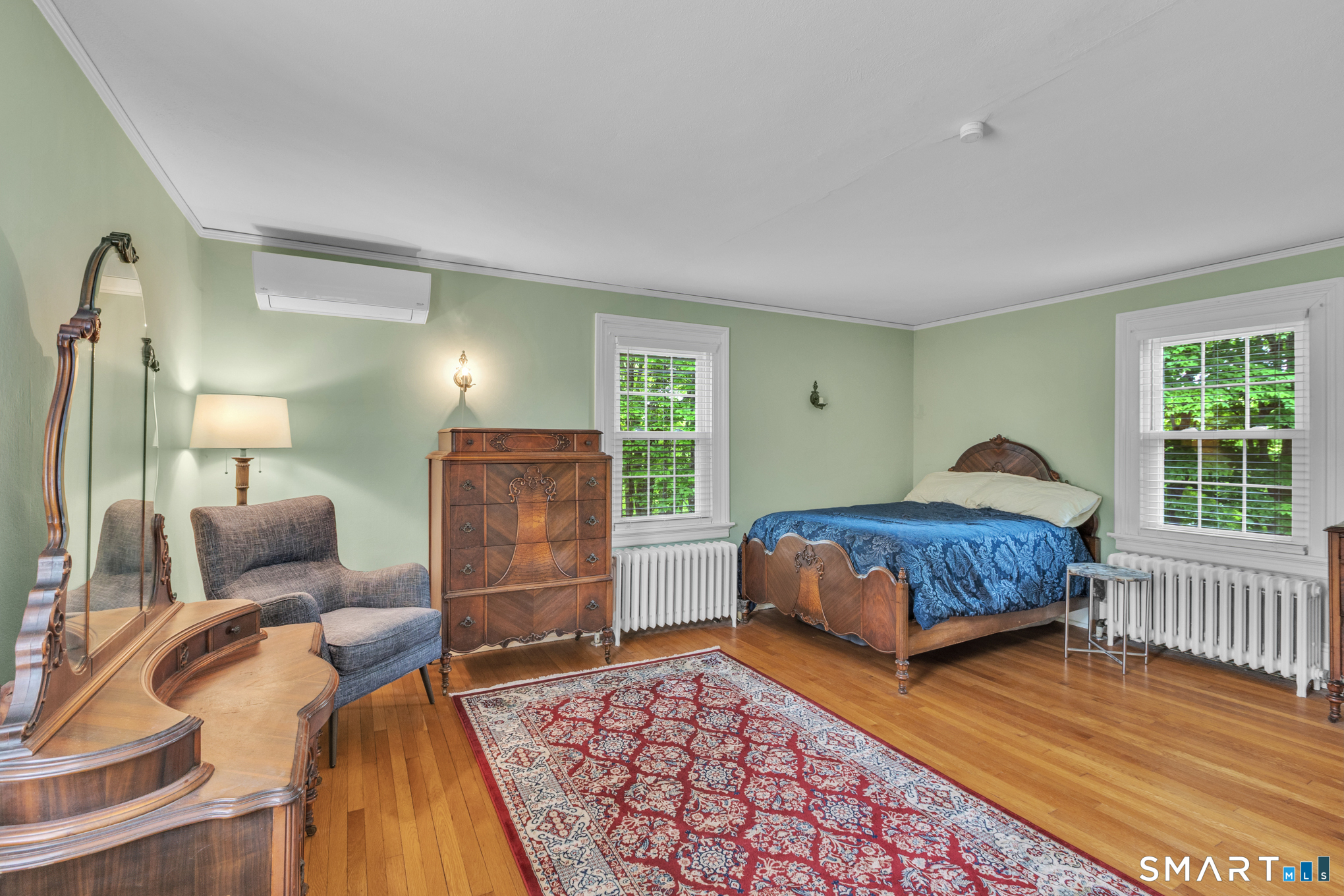 808 Branch Road Suffield, CT 06078 - Photo 23 of 40 a bedroom with a bed and wooden floor