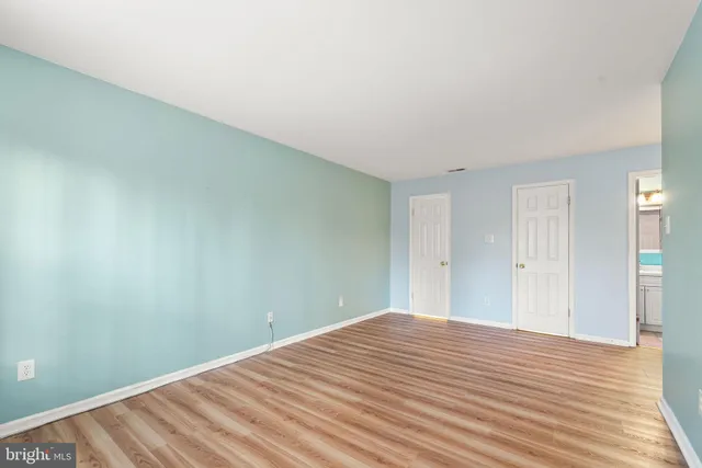 a view of a room with wooden floor and bathroom