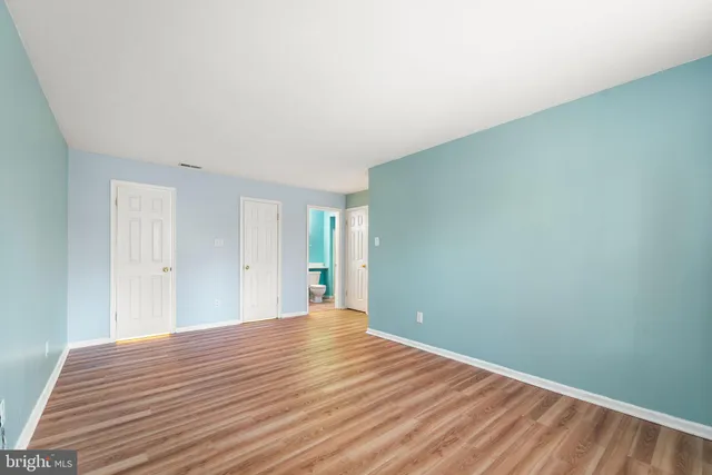 a view of a room with wooden floor