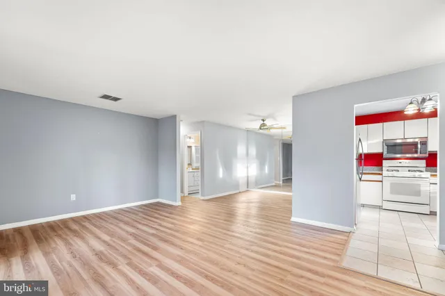 a view of empty room with wooden floor
