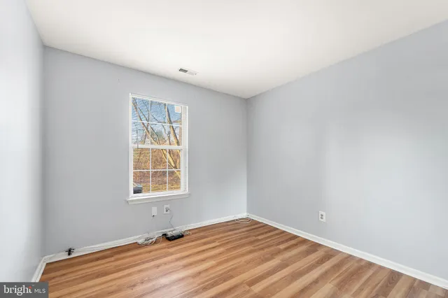 a room with a window and a wooden floor