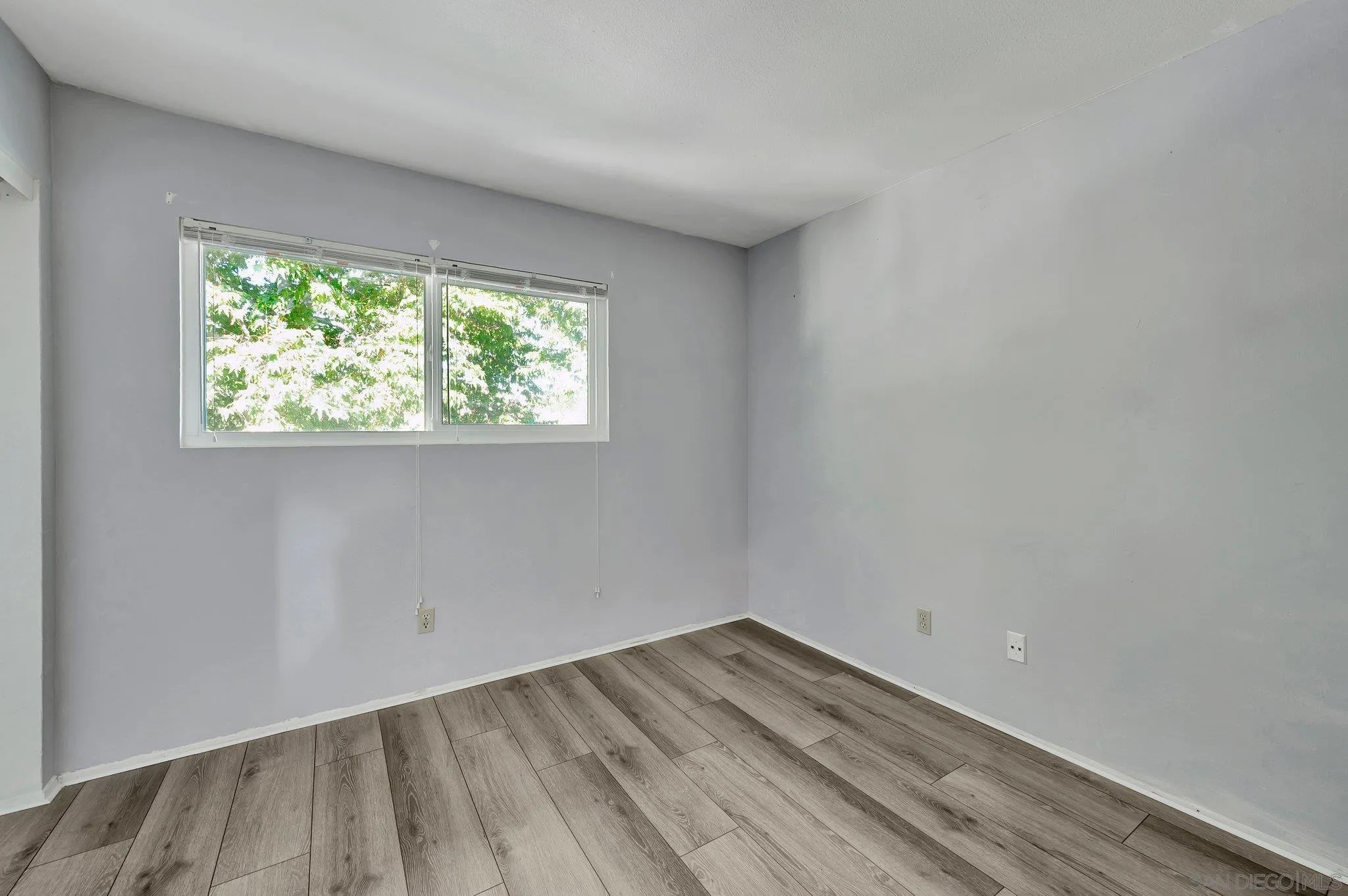 14247 Anabelle Drive Poway, CA 92064 - Photo 21 of 33 an empty room with wooden floor and windows