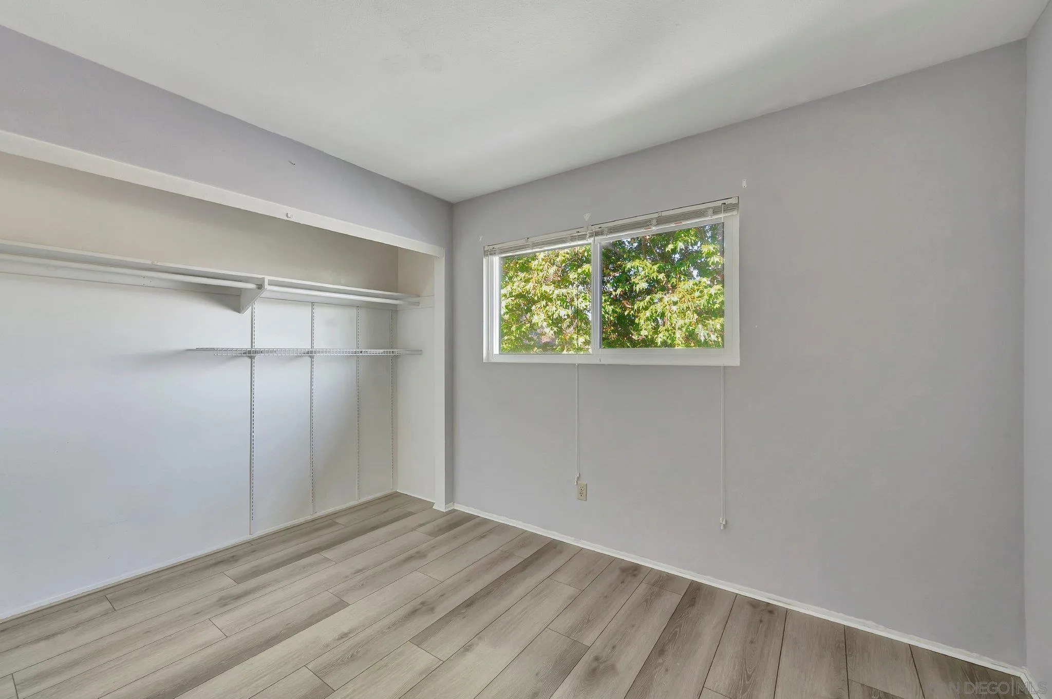 14247 Anabelle Drive Poway, CA 92064 - Photo 22 of 33 a view of an empty room with wooden floor and a window