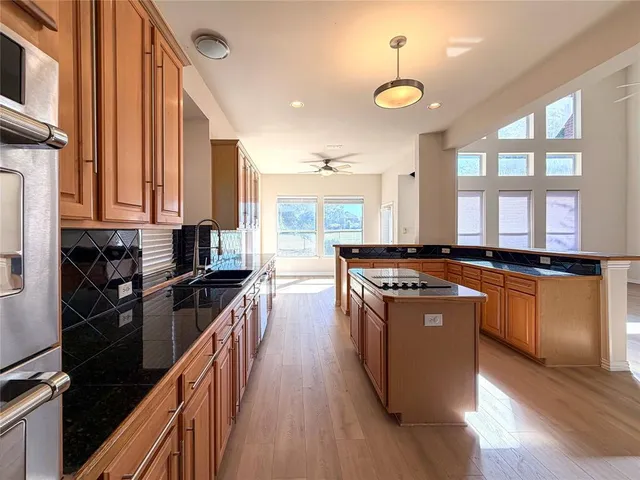 a kitchen with stainless steel appliances granite countertop a stove and a refrigerator