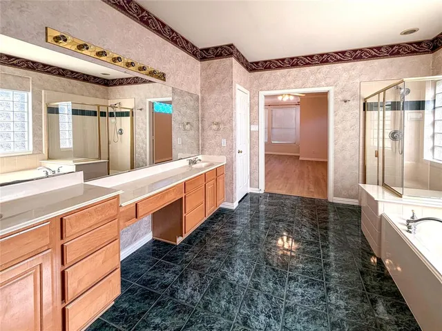 a large bathroom with a double vanity sink and a large mirror