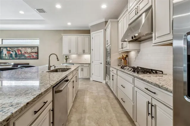 a view of a dining room with furniture a chandelier and wooden floor