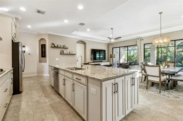 a bathroom with a granite countertop bathtub a sink and a large mirror