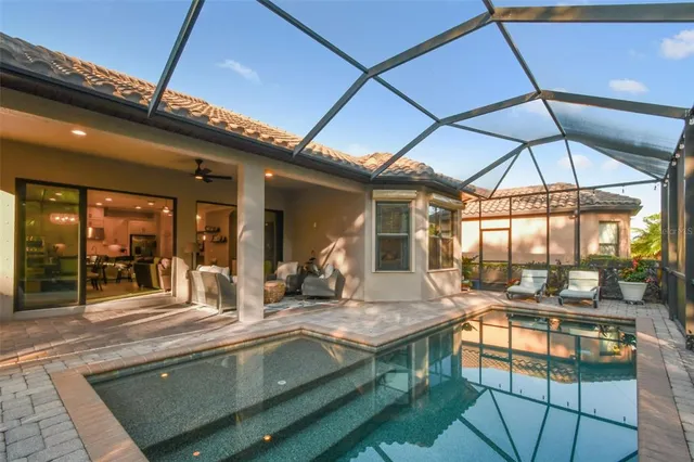 a view of a livingroom with furniture and floor to ceiling window