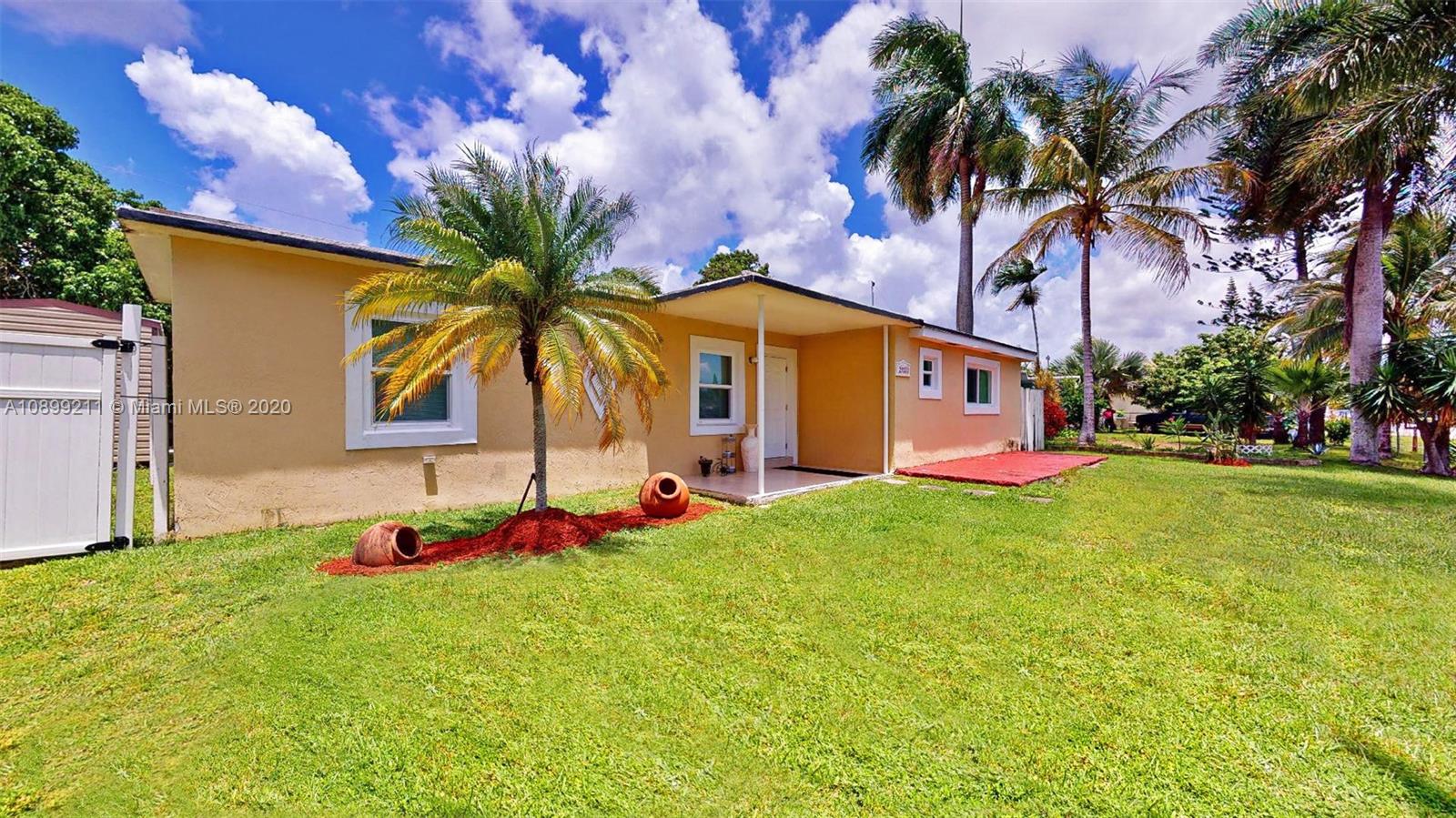 29120 Kansas Road Homestead, FL 33033 - Photo 1 of 24 a front view of a house with garden