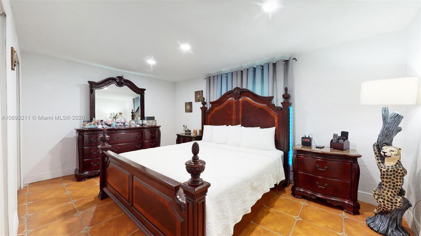 29120 Kansas Road Homestead, FL 33033 - Photo 13 of 24 a living room with a bed and dresser