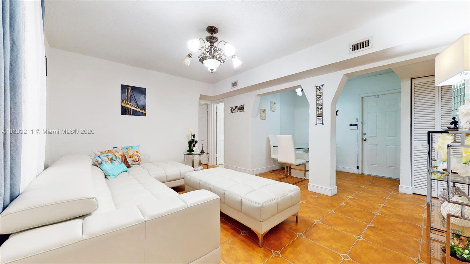 29120 Kansas Road Homestead, FL 33033 - Photo 5 of 24 a spacious bedroom with a bed and chandelier