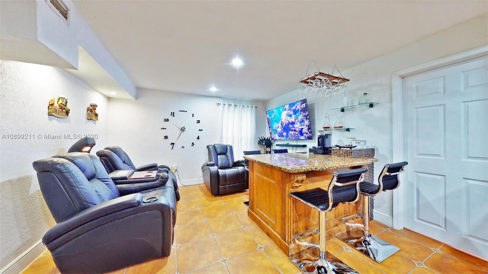 29120 Kansas Road Homestead, FL 33033 - Photo 9 of 24 a living room with furniture a dining table and a chandelier