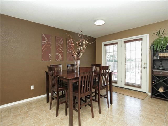 1008 Apollo Circle Round Rock, TX 78664 - Photo 12 of 33 a view of a dining room with furniture and a floor to ceiling window