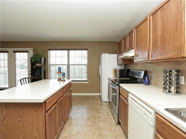 1008 Apollo Circle Round Rock, TX 78664 - Photo 16 of 33 a kitchen with a sink stove and refrigerator