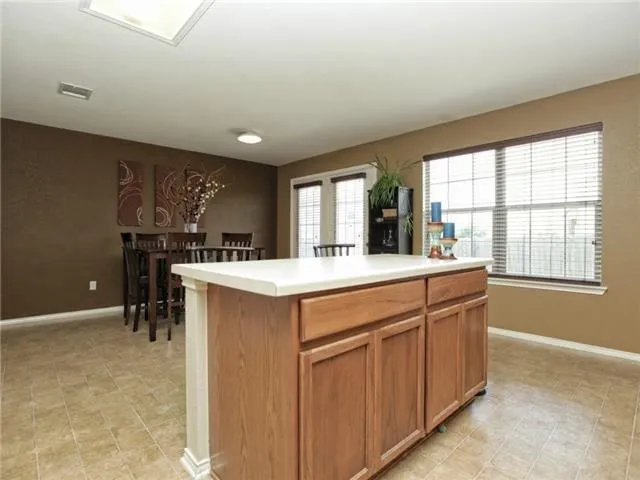 a kitchen with kitchen island a sink stainless steel appliances and cabinets