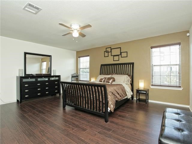1008 Apollo Circle Round Rock, TX 78664 - Photo 20 of 33 a bedroom with a bed and wooden floor