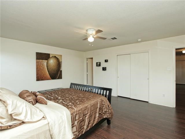 1008 Apollo Circle Round Rock, TX 78664 - Photo 21 of 33 a bedroom with bed and a chandelier