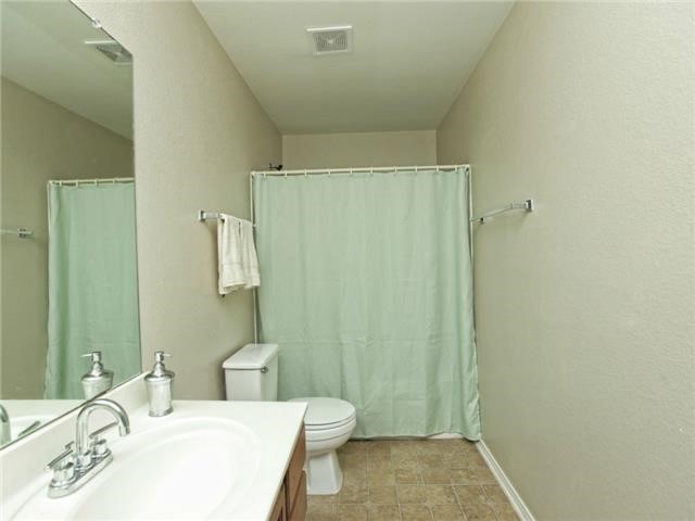 1008 Apollo Circle Round Rock, TX 78664 - Photo 23 of 33 a bathroom with a sink a toilet and shower