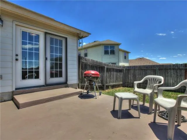 a patio with a table and chairs