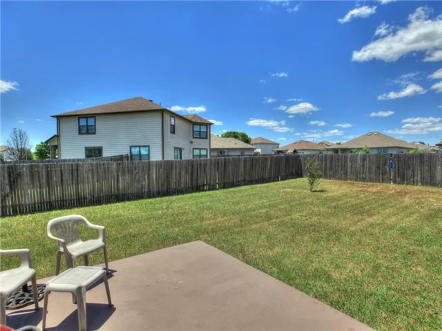 1008 Apollo Circle Round Rock, TX 78664 - Photo 29 of 33 a view of a backyard with table and chairs with wooden fence