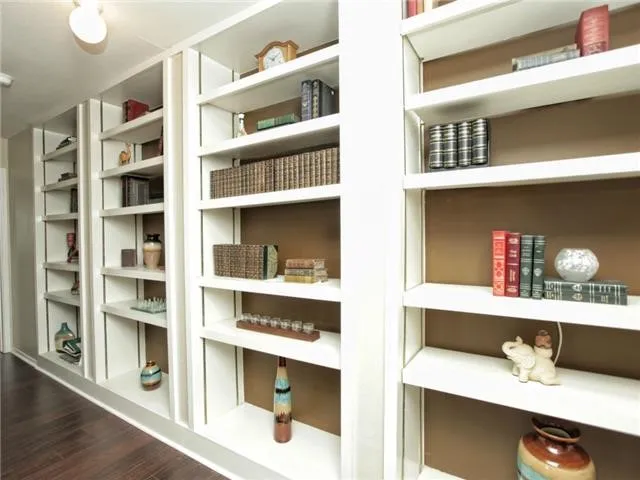 a shelf with books and knick knacks on it