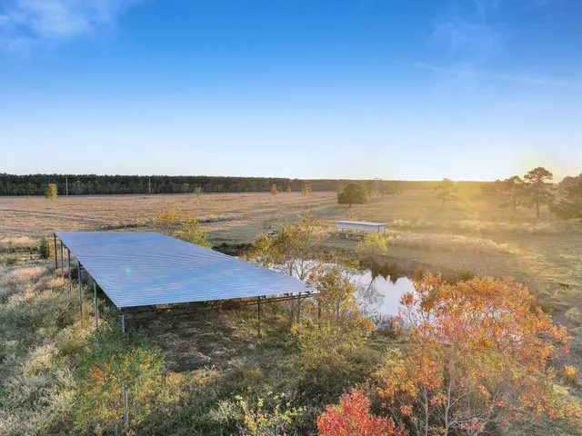 a view of lake with green field and mountain view