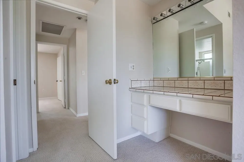 7114 Columbine Drive Carlsbad, CA 92011 - Photo 12 of 16 a bathroom with a sink and a mirror