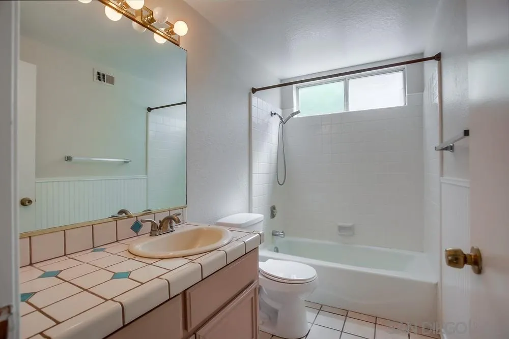 7114 Columbine Drive Carlsbad, CA 92011 - Photo 15 of 16 a bathroom with a granite countertop sink toilet and shower