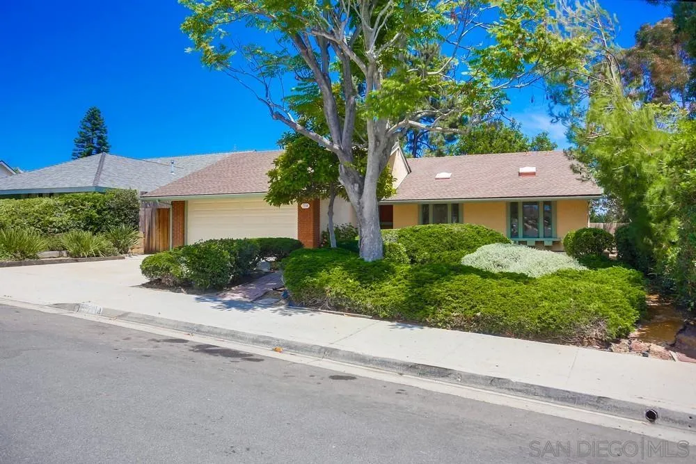 7114 Columbine Drive Carlsbad, CA 92011 - Photo 2 of 16 a front view of a house with a yard and trees