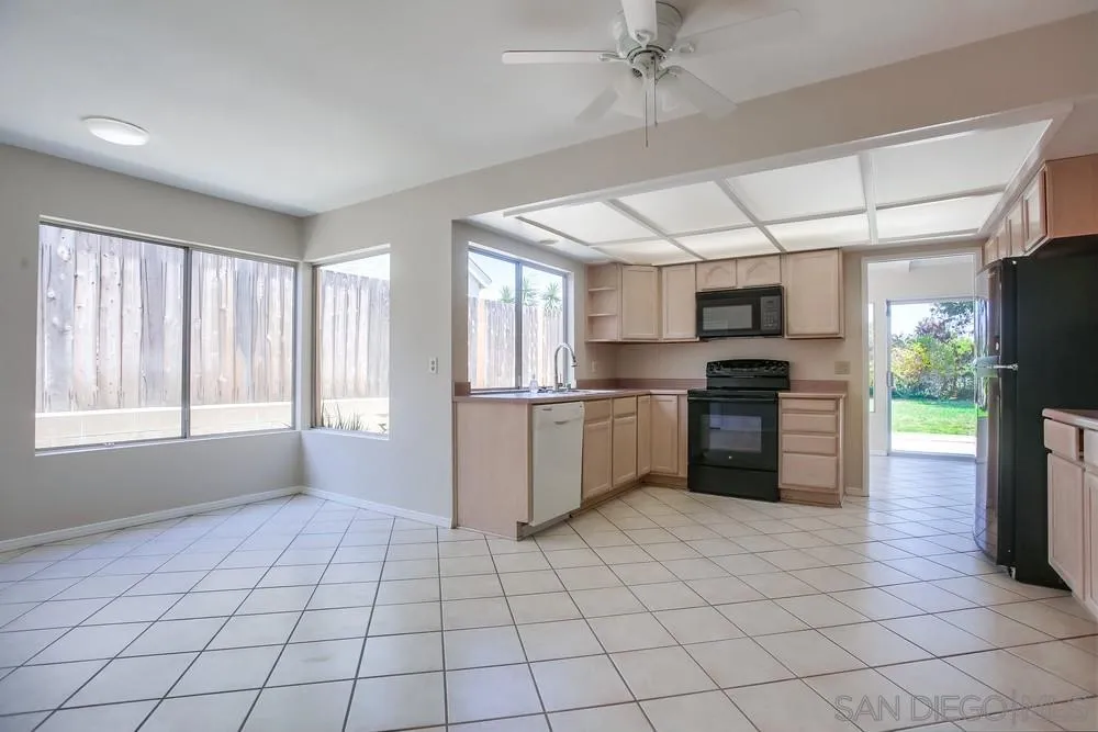 7114 Columbine Drive Carlsbad, CA 92011 - Photo 7 of 16 a kitchen with stainless steel appliances a refrigerator sink and microwave