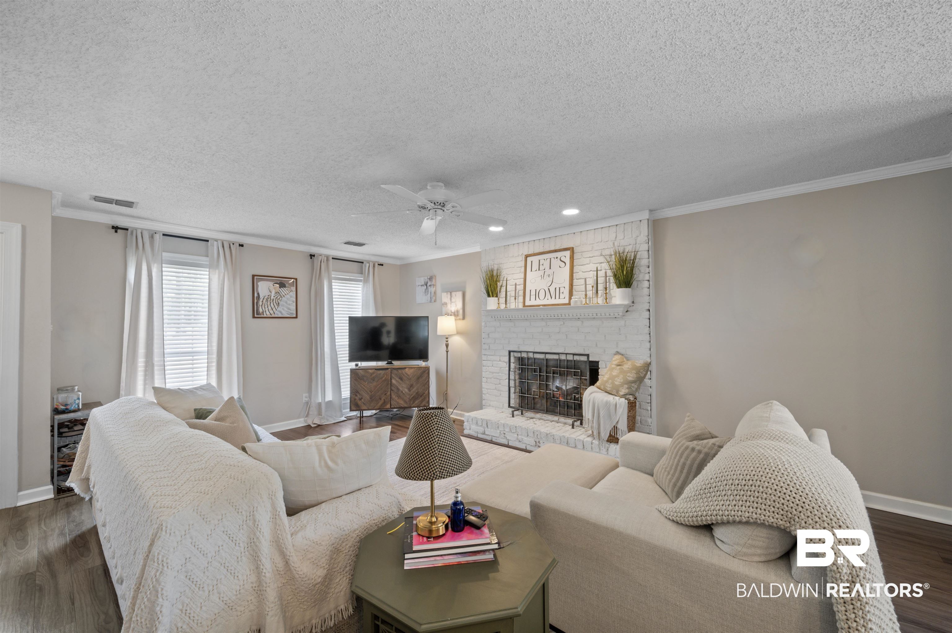 1066 Linlen Avenue Mobile, AL 36609 - Photo 6 of 22 Living area with crown molding, baseboards, a fireplace, wood finished floors, and ceiling fan