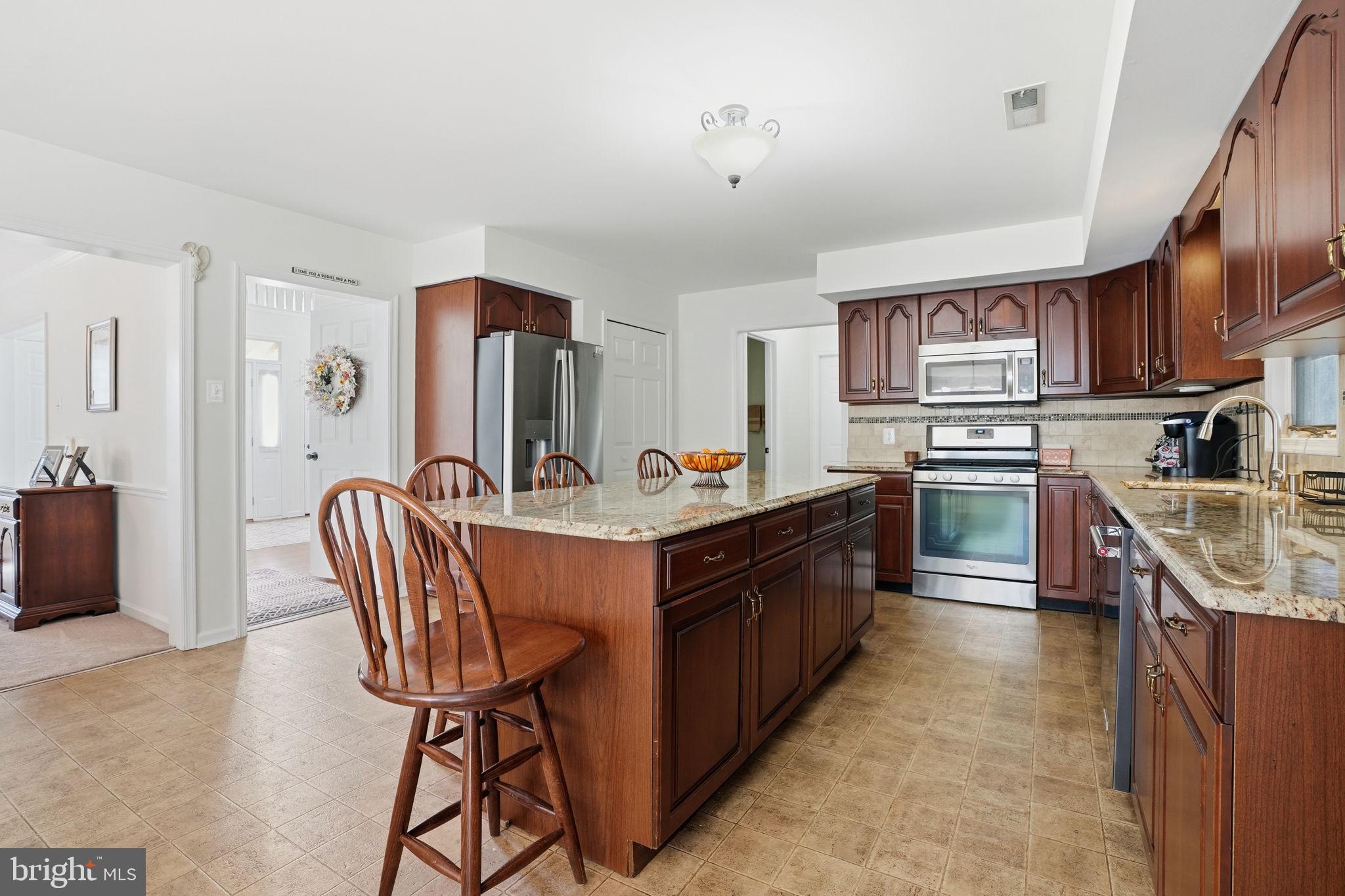 3 Swallow Road Holland, PA 18966 - Photo 12 of 45 a kitchen with stainless steel appliances granite countertop a sink a stove and a refrigerator