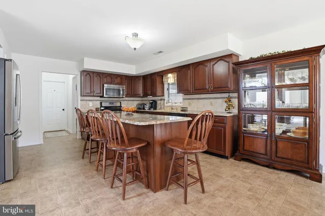 a dining room with furniture a window and kitchen view
