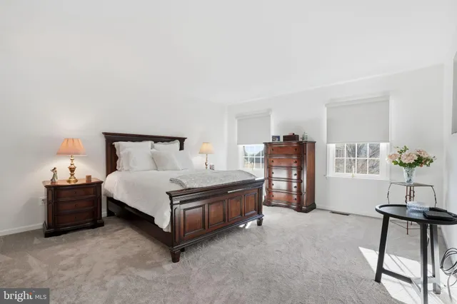 a bed room with a bed and a chair