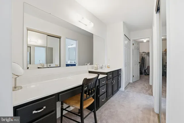 a spacious bathroom with a granite countertop sink a mirror and a