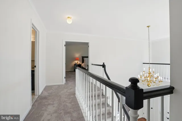 a view of a hallway to room with furniture
