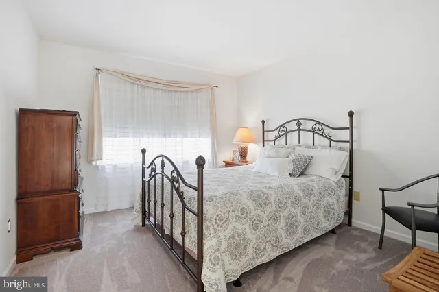 a bedroom with bed and a window