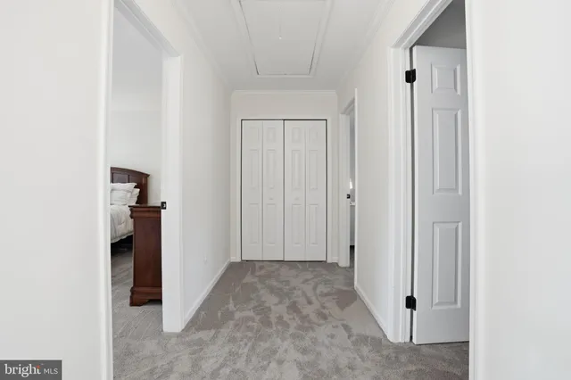 a view of a hallway with wooden shelves